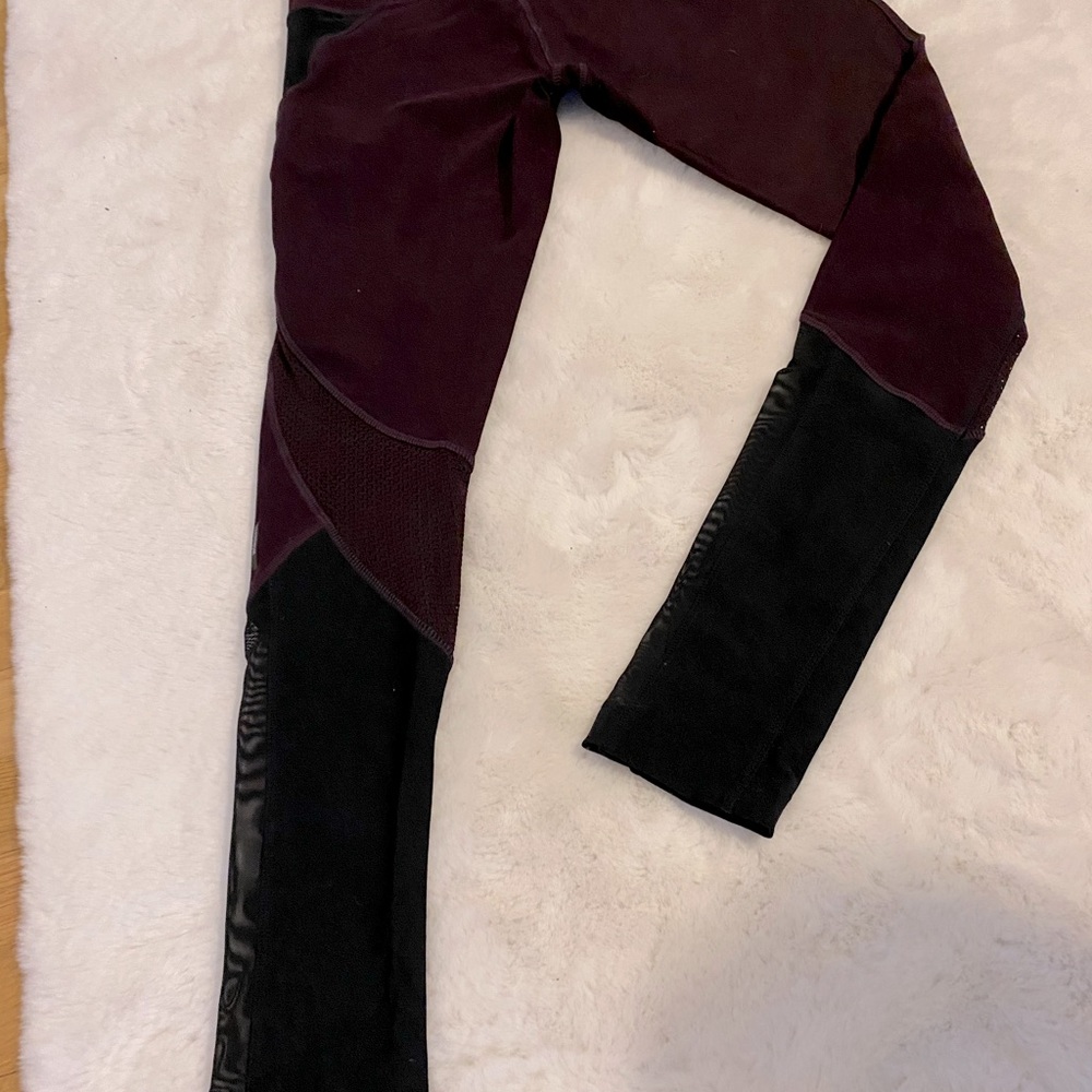 Mid-rise maroon and black leggings.